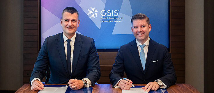 Dr. Bastian Giegerich, Director-General and Chief Executive of IISS, and Heiko M. Stutzinger standing side by side, looking into the camera.
